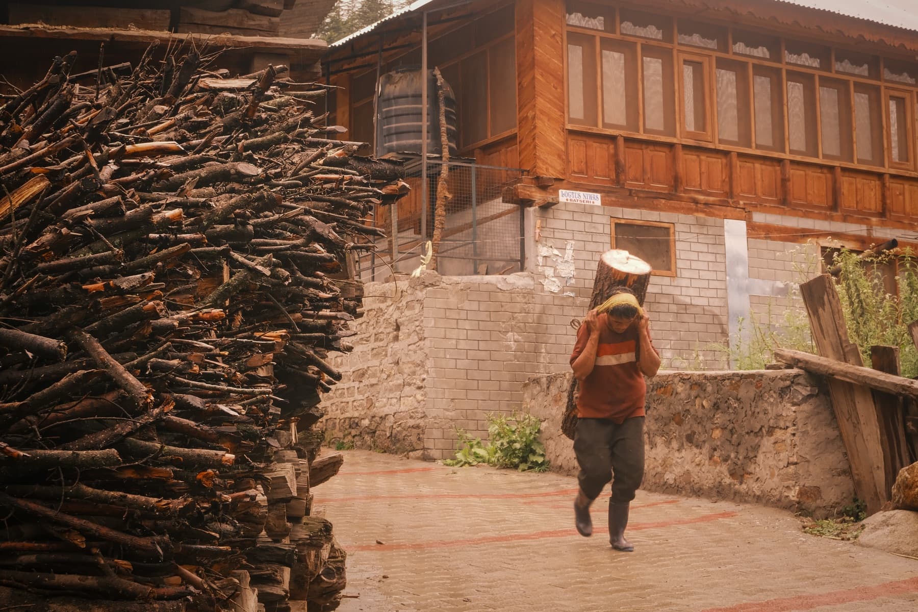 Village lane, firewood stacked for winter